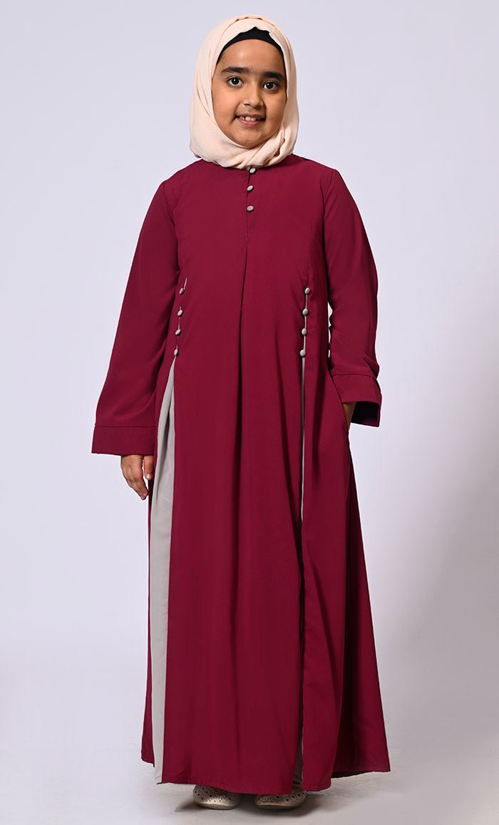 Pleated Perfection: Girl's Maroon Abaya with buttons detailing & Side Pockets